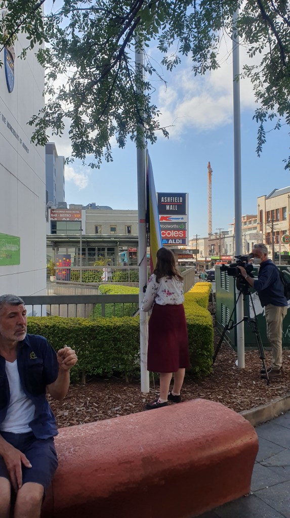 A disabled person raises the flag

