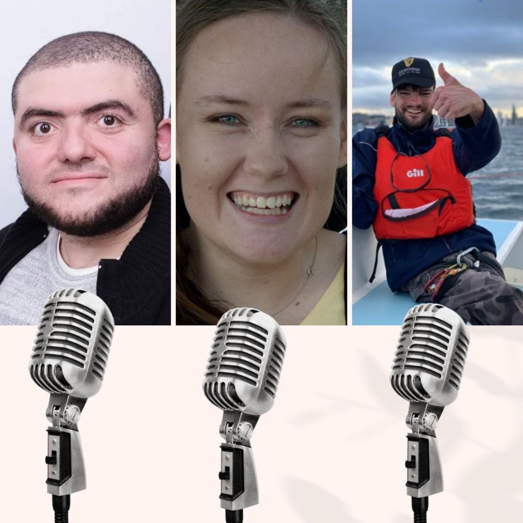 A bald man, a smiling woman, and a man in a life jacket giving thumbs up, Below them are microphones 